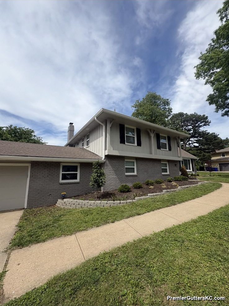 1990s tri-level board-and-batten KC home with new seamless gutters