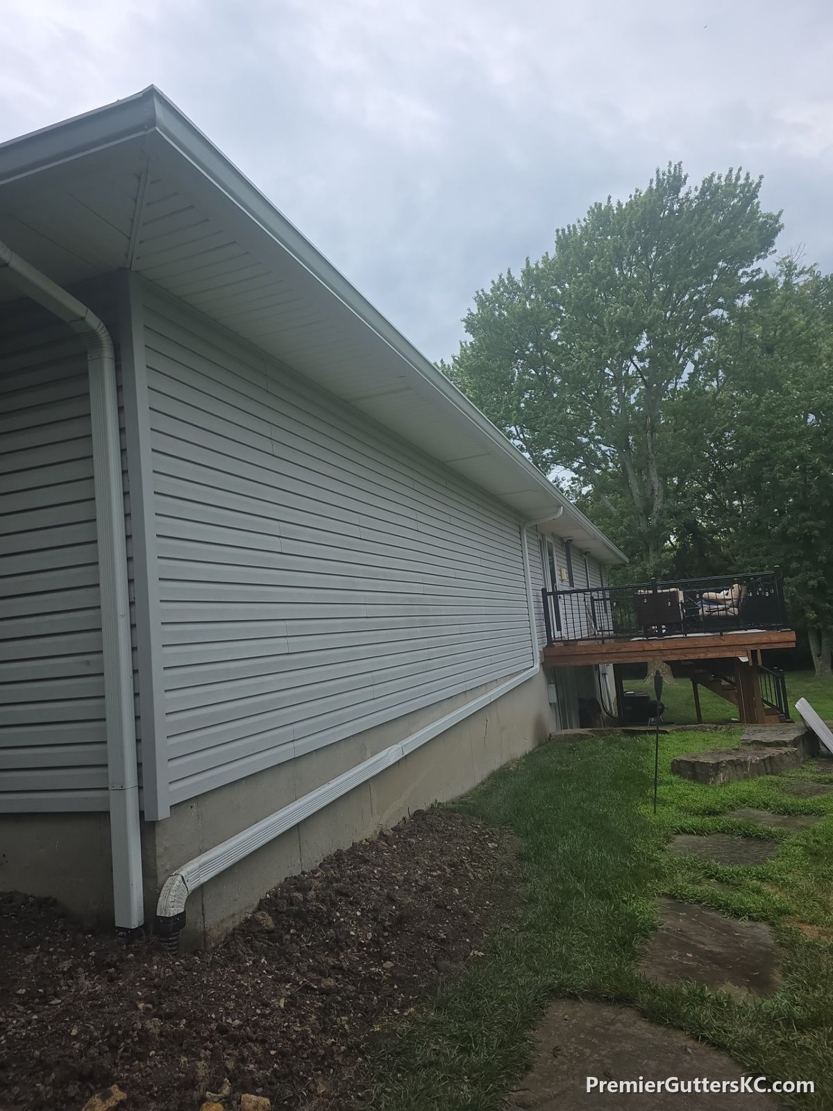 Downspout tied into an underground drain line on a walkout ranch in De Soto, Kansas