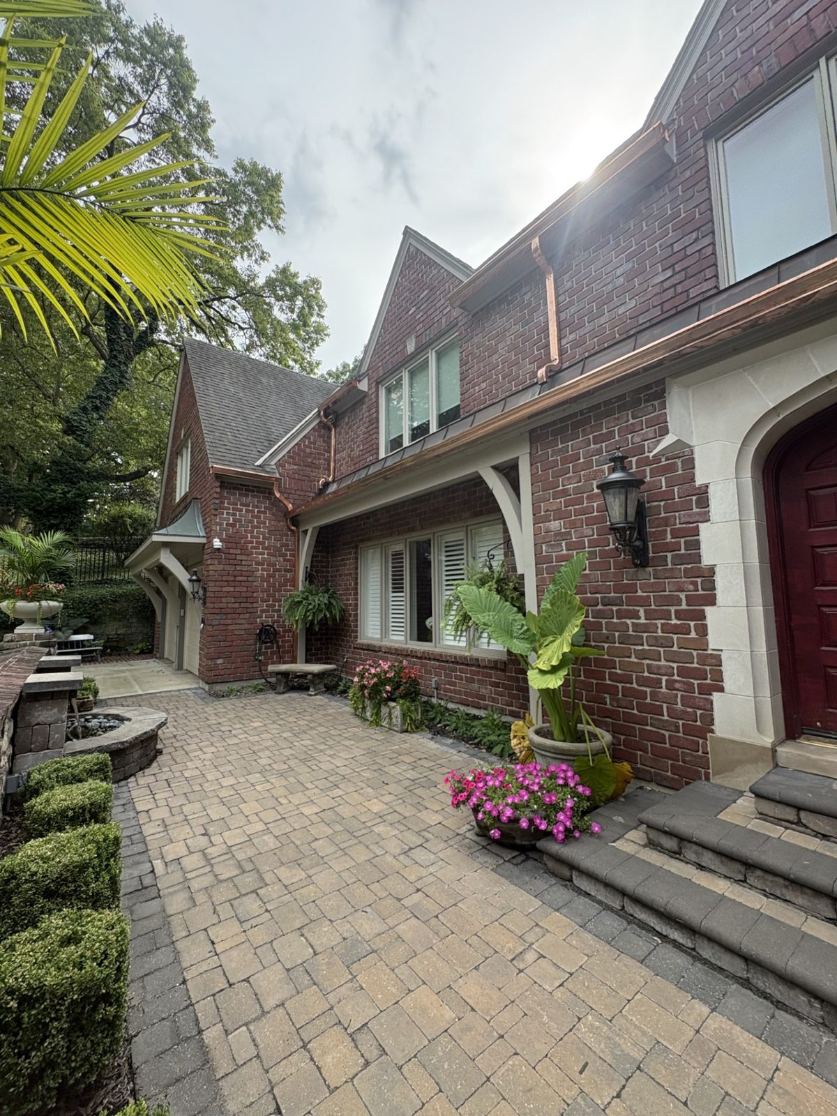 Copper gutters and downspouts along the courtyard rooflines of a brick Tudor home in the Kansas City metro