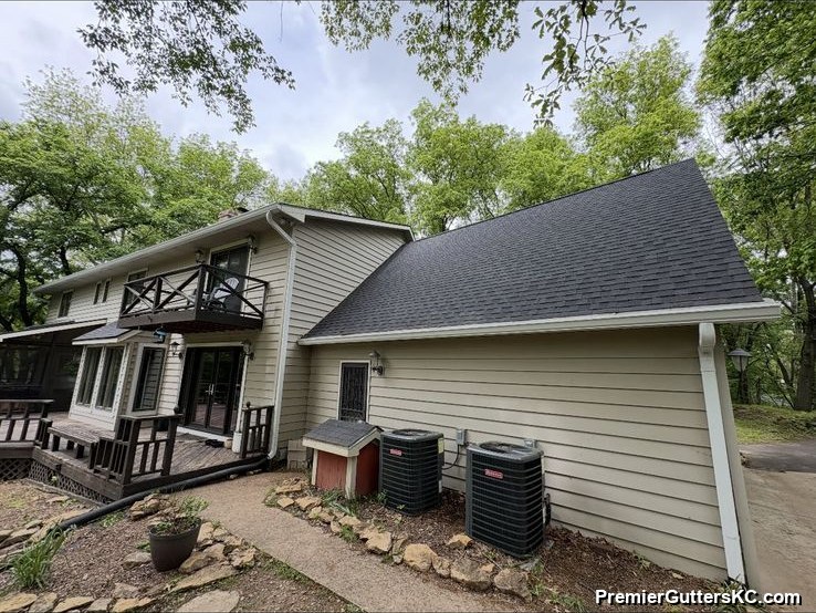 Downspout routed to AC pad on lake walkout home in Kansas City
