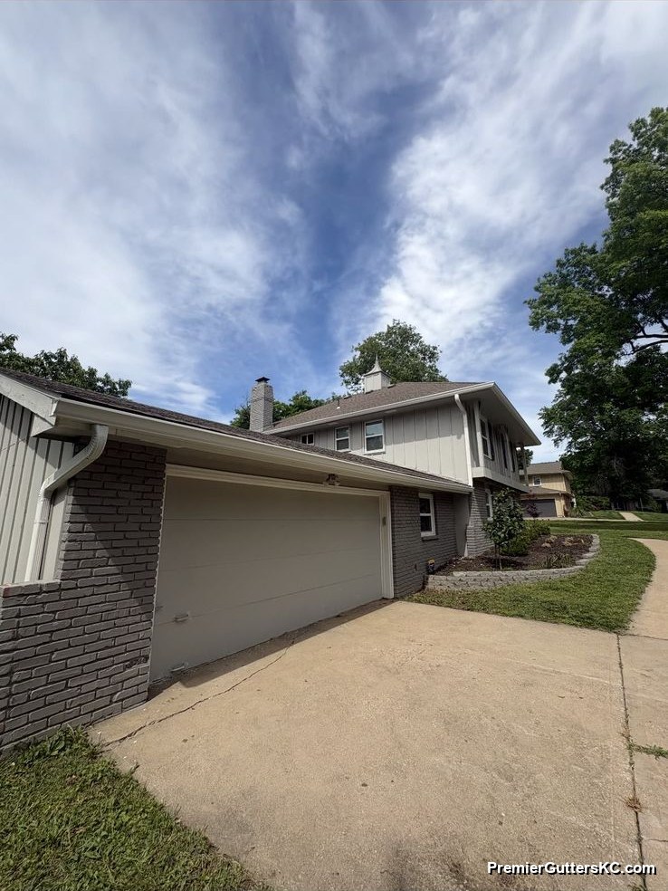 New downspout with extension on newer-build board-and-batten Kansas City home