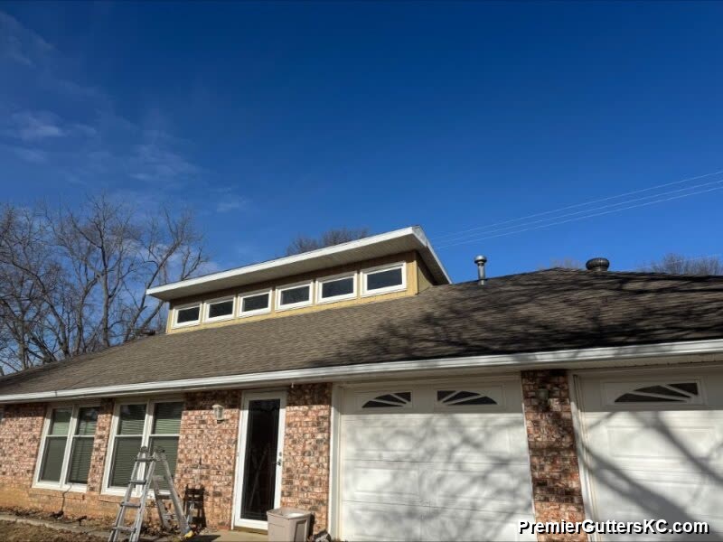 New seamless gutter installation on brick ranch with dormer addition in Kansas City