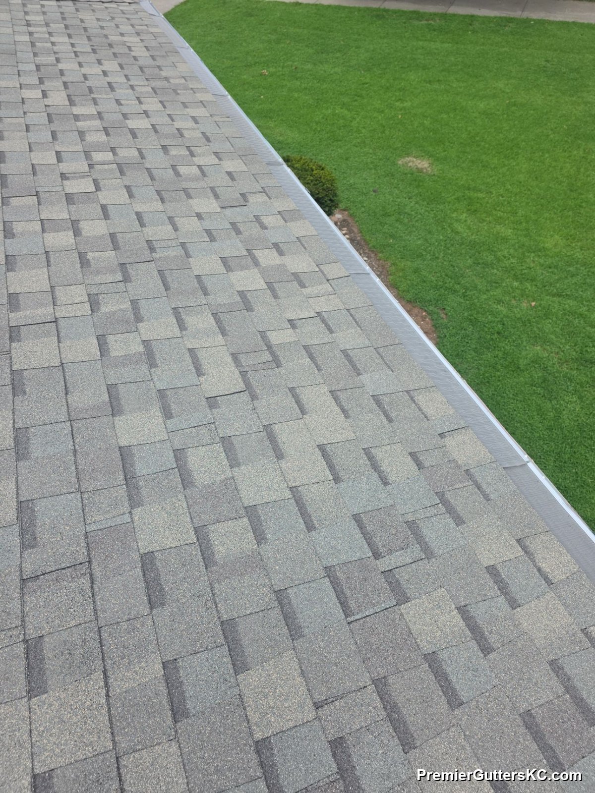 LeafBlaster Pro stainless micromesh gutter guards running the full length of a shingle roofline on a Kansas City, MO home